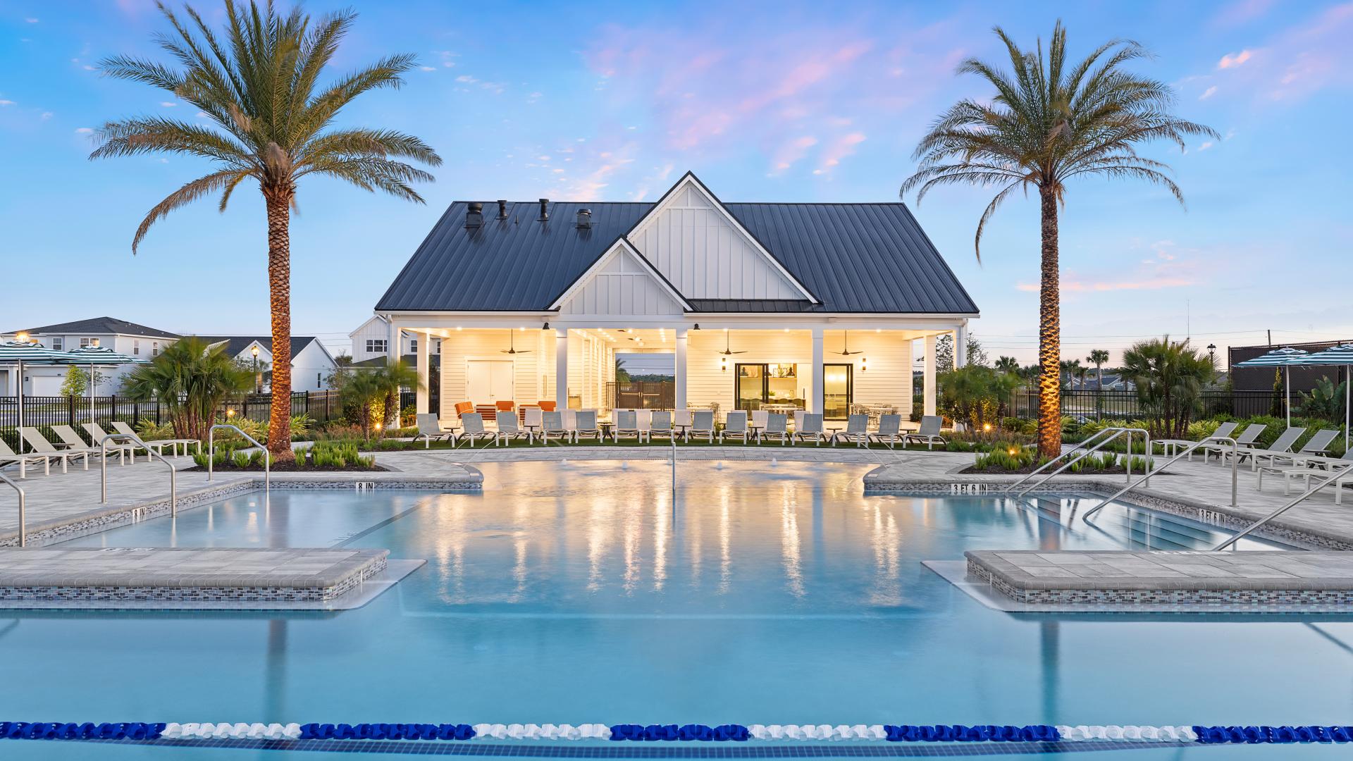 Twilight view of the Bronson Peak clubhouse pool and amenities